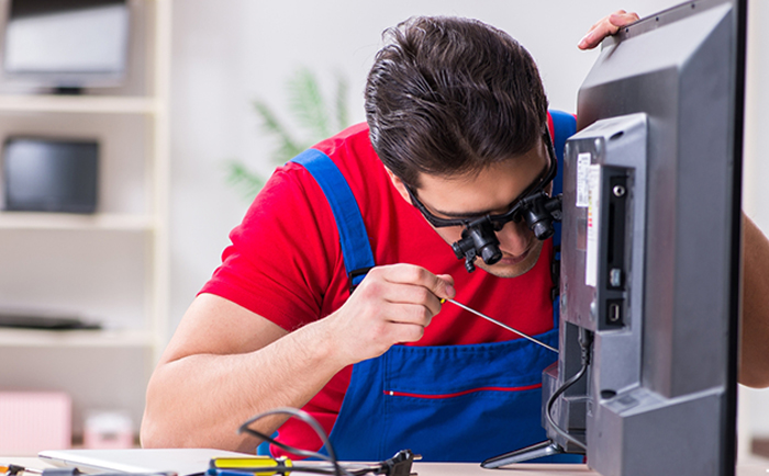 Technician repairing a Sony television at home